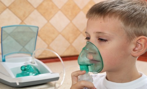 Child using an inhealer during an Asthma attck